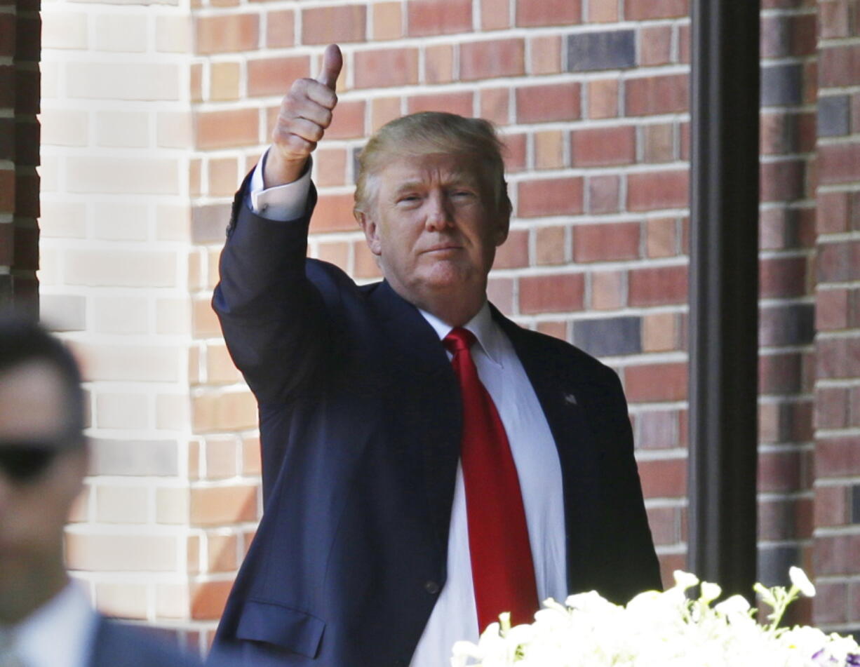 Republican presidential candidate Donald Trump gives a thumbs-up as he leaves the residence of Indiana Gov. Mike Pence in Indianapolis on Wednesday.