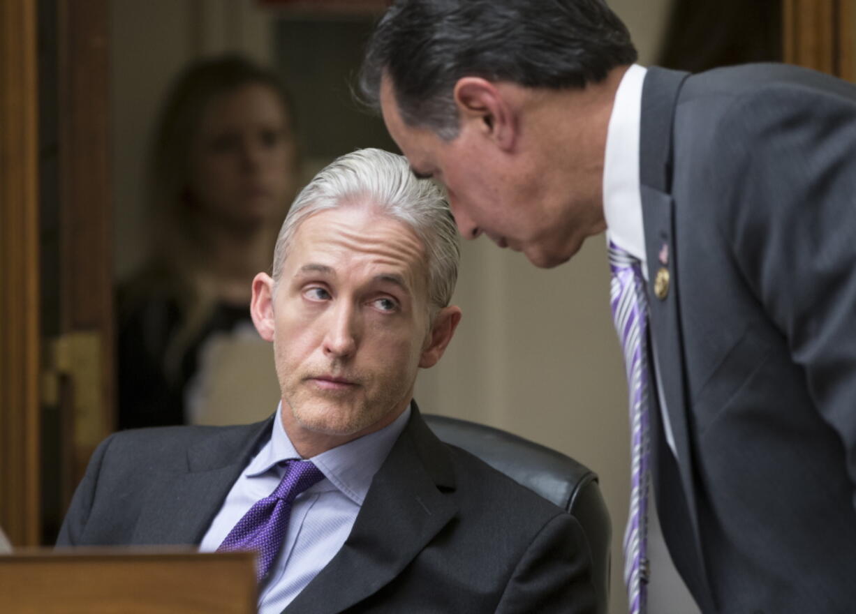 Rep. Trey Gowdy, R-S.C., chairman of the House Select Committee on Benghazi, confers with Rep. Gary Palmer, R-Ala., right, as they and members of the House Oversight Committee question FBI Director James Comey on Thursday about his decision to not prosecute Hillary Clinton over her private email setup while she was secretary of state. (j.