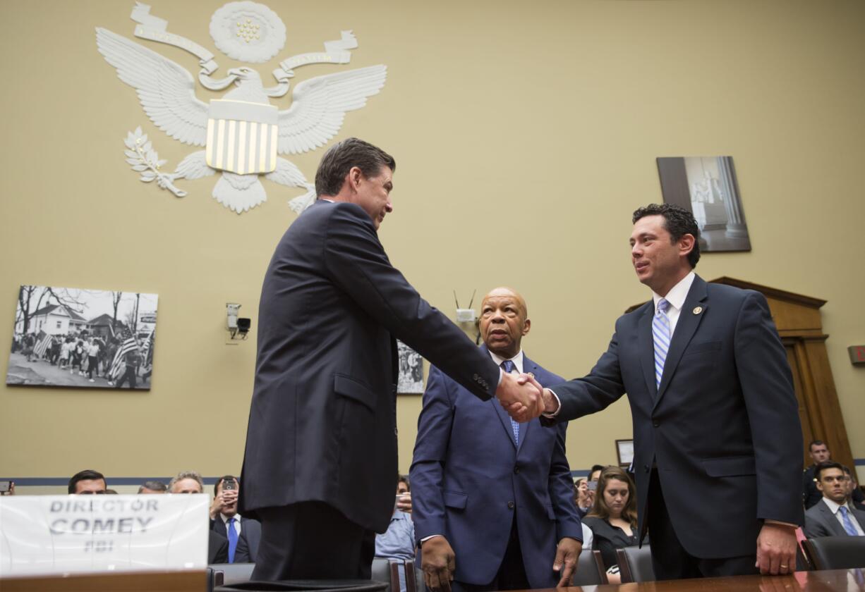 House Oversight and Government Reform Committee Chairman Rep. Jason Chaffetz, R-Utah, right, accompanied by the committee's ranking member Rep. Elijah Cummings, D-Md., center, welcome FBI Director James Comey, on Capitol Hill in Washington, Thursday, July 7, 2016, prior to Comey testifying before the committee's hearing  to explain the agency's recommendation to not prosecute Democratic presidential candidate Hillary Clinton over her private email setup as secretary of state. (AP Photo/J.