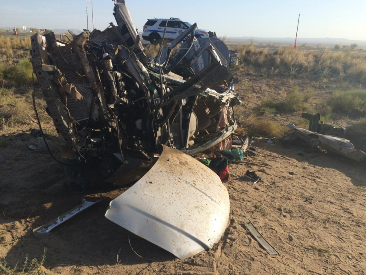 The wreckage of a van that collided with a Dallas Cowboys bus is seen near Kingman, Ariz., on Sunday. Authorities said multiple people in the van died but nobody on the bus was seriously injured.