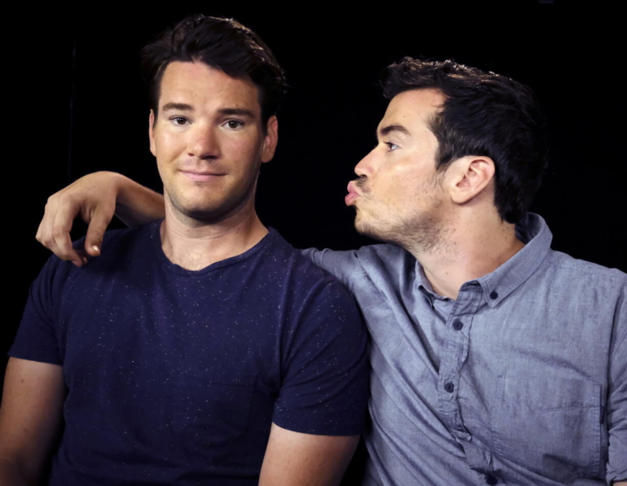 Mike Stangle, right, blows a kiss to his brother Dave during a June 29 interview in Los Angeles. The brothers posted an ad on Craigslist in search of dates for a cousin&#039;s wedding back in 2013. The ad went viral and the two parlayed a slew of crazy dates into book and a movie deal.