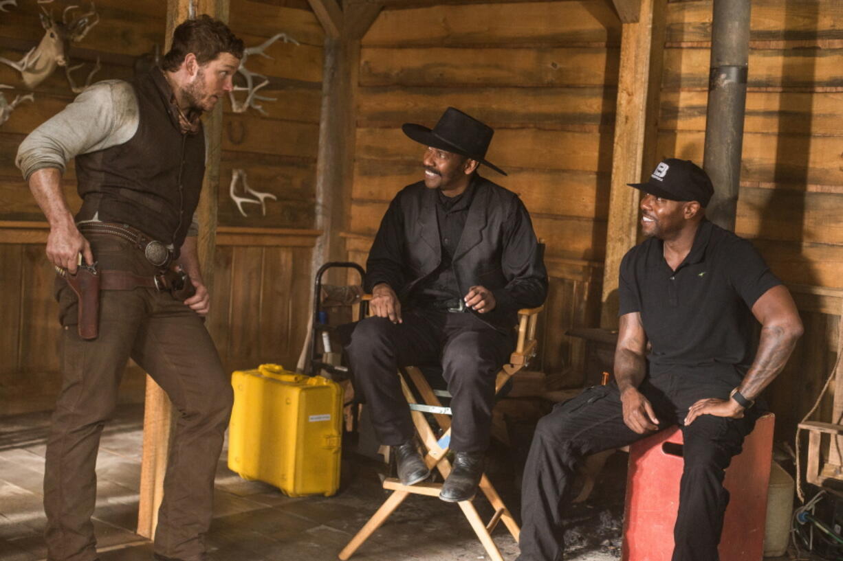 Chris Pratt, left, and Denzel Washington, center, appear on the set with director Antoine Fuqua during the filming of &quot;The Magnificent Seven.&quot; The film will have its world premiere as the opening film of the 41st Toronto International Film Festival.