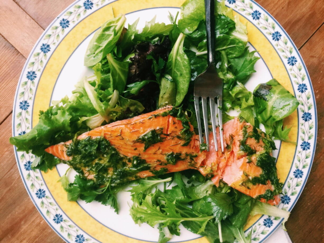 This warm-weather recipe combines salmon bathed in olive oil and herbs with springy greens and salad. It&#039;s the kind of lighter, brighter meal we tend to want during summer.