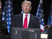 Republican presidential candidate Donald Trump, center, checks a video monitor as he talks with production crew during a walk through in preparation for his speech at the Republican National Convention, Thursday in Cleveland.