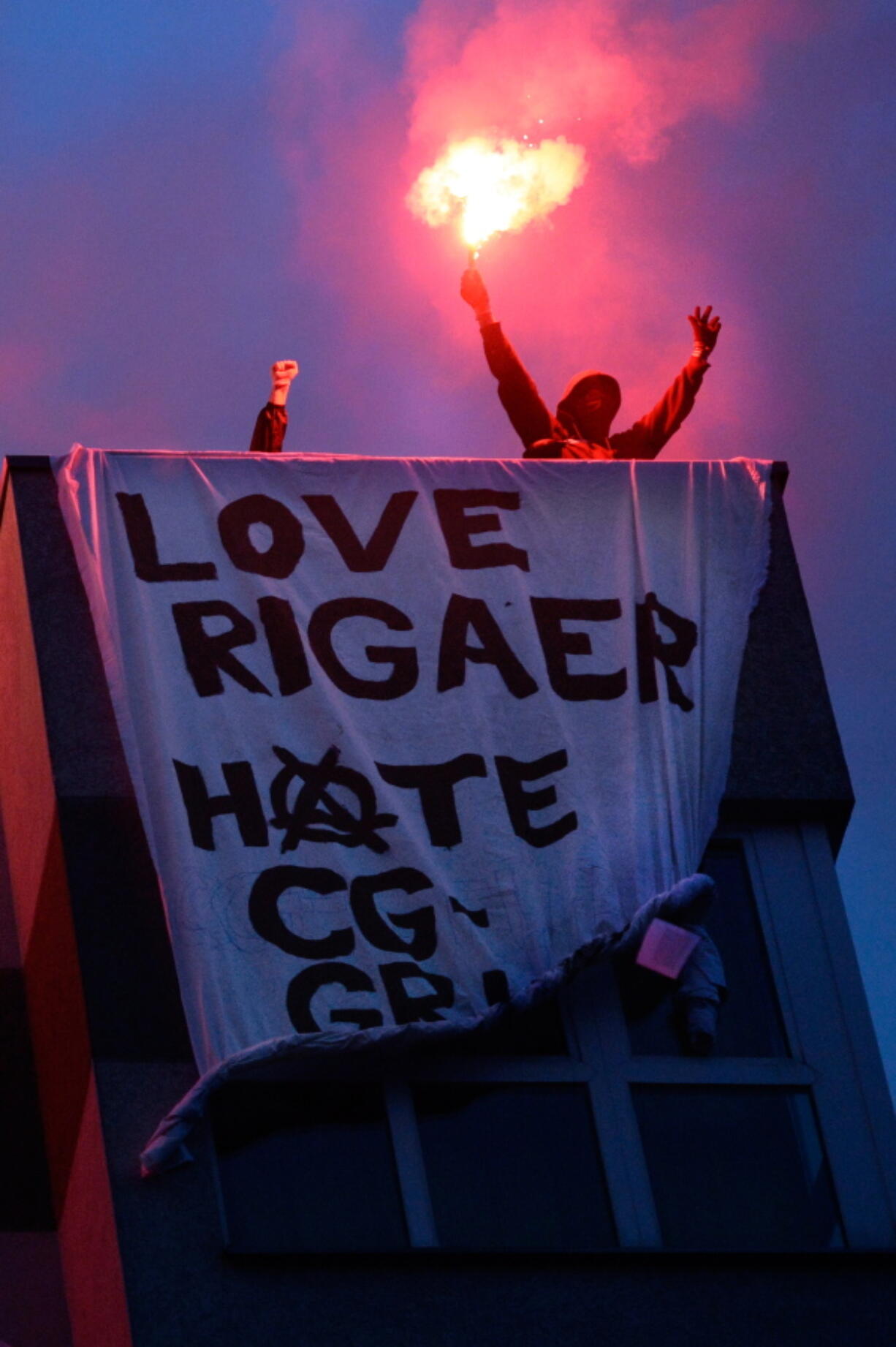 Protesters demonstrate on the roof of a house in Berlin, Germany. Police say more than 120 officers were injured and some 86 demonstrators were detained during leftist riots in the German capital which police calls the most aggressive and violent protests in the last five years. Berlin police said in a statement Sunday leftist protesters threw bottles, cobble stones and fireworks, destroyed cars and attacked officers with fists and kicks. It was not clear how many rioters were injured in the quarrels.