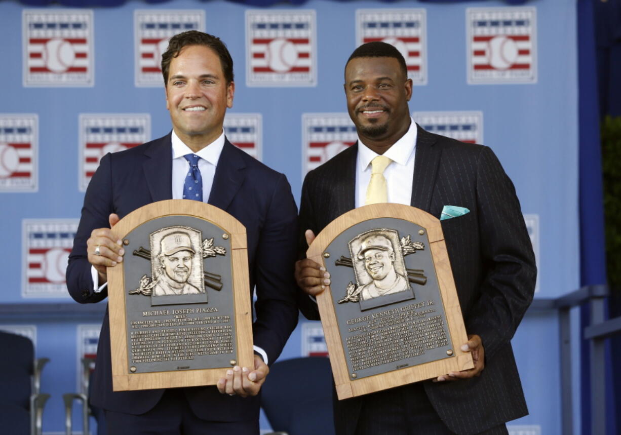 National Baseball Hall of Fame inductees Mike Piazza, left, and Ken Griffey Jr. hold their plaques after an induction ceremony at the Clark Sports Center on Sunday, July 24, 2016, in Cooperstown, N.Y.