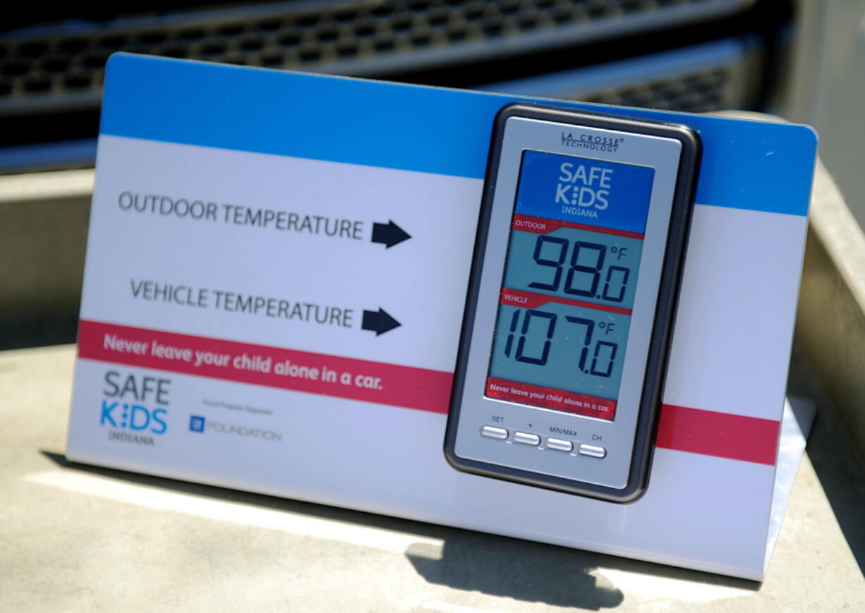 FILE - In this July 30, 2015 file photo, St. Mary&#039;s and Safe Kids Coalition uses a wireless monitor to record the temperature outside and inside of a closed vehicle at St. Mary&#039;s Market Days in Evansville, Ind. The deaths of four children in hot cars in recent days has brought the number of such deaths across the U.S. this year to at least 23, nearly matching the total for all of 2015 and prompting experts to plead for vigilance and warn parents that it can happen to anyone.