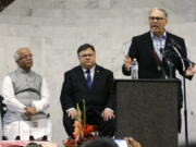 Gov. Jay Inslee, right, speaks Wednesday during a prayer service at the Muslim Association of Puget Sound Redmond Mosque in Redmond that marked the end of Ramadan and the start of Eid-al-Fitr. Seated are association president Mahmood Khadir, left, and Redmond Mayor John Marchione. (Ted S.