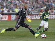 Colorado Rapids goalkeeper Tim Howard, front, clears the ball as Portland Timbers forward Diego Chara defends in the first half of an MLS soccer match Monday, July 4, 2016, in Commerce City, Colo.