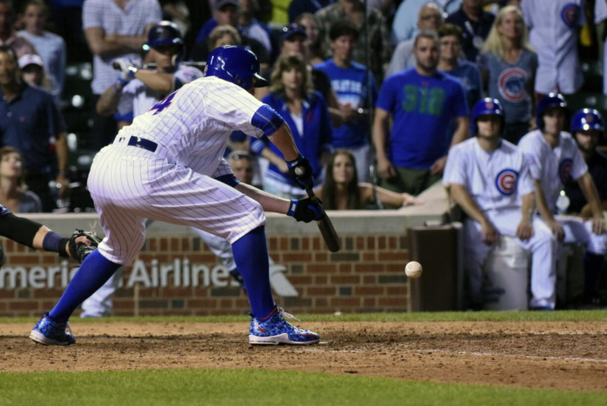 Chicago Cubs Jon Lester (34) hits a game winning sacrifice bunt which scored Jason Heyward in the twelfth inning of a baseball game against the Seattle Mariners on Sunday, July 31, 2016, in Chicago.