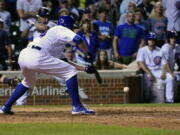 Chicago Cubs Jon Lester (34) hits a game winning sacrifice bunt which scored Jason Heyward in the twelfth inning of a baseball game against the Seattle Mariners on Sunday, July 31, 2016, in Chicago.