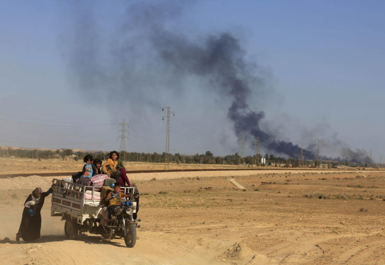 Smoke rises as people flee their homes in April during clashes between Iraqi security forces and members of the Islamic State group in Hit, Iraq, 85 miles west of Baghdad. Iraq&#039;s government is setting its sight on Mosul, Iraq&#039;s second-largest city that has been under Islamic State control since June 2014, as its next major target in the fight.