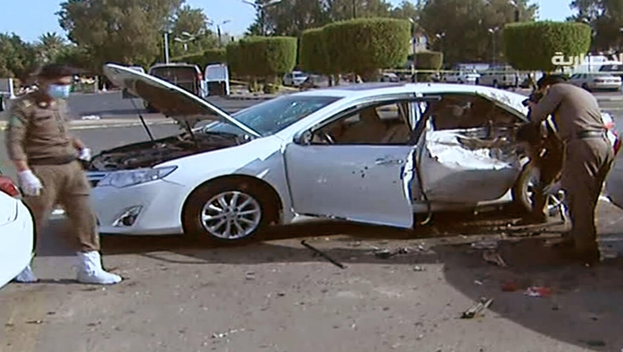 In this Monday grab from footage released by Al-Ekhbariya, Saudi security forces investigate the scene of an explosion in Jeddah, Saudi Arabia. A suicide bomber carried out an attack early Monday near an American diplomatic site in the western Saudi city of Jeddah, according to the Interior Ministry.