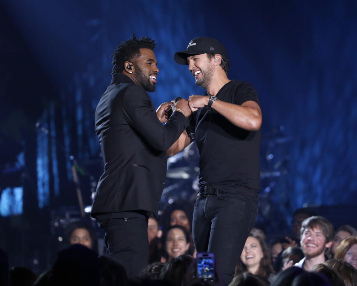 Jason Derulo, left, and Luke Bryan perform March 29 during a taping of CMT Crossroads in Franklin, Tenn.