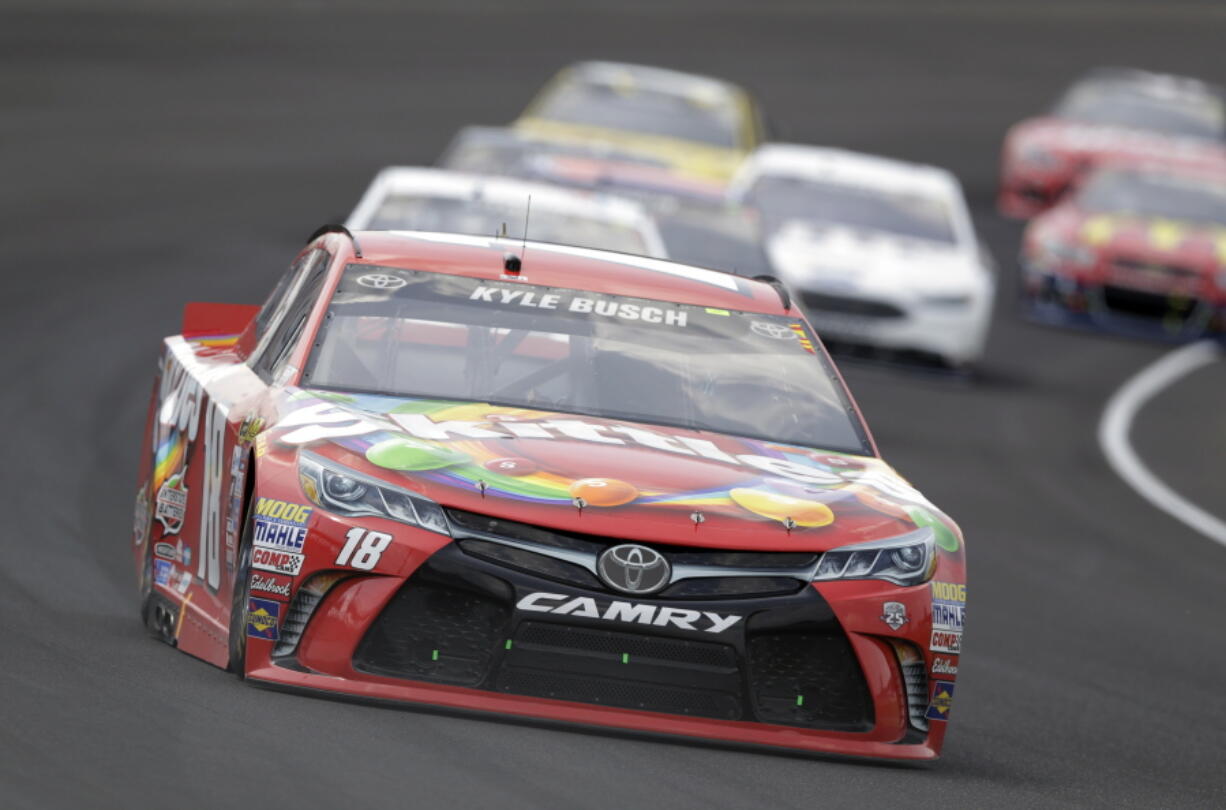 Kyle Busch (18) drives through the first turn during the Brickyard 400 NASCAR Sprint Cup auto race at Indianapolis Motor Speedway in Indianapolis, Sunday, July 24, 2016.