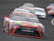 Kyle Busch (18) drives through the first turn during the Brickyard 400 NASCAR Sprint Cup auto race at Indianapolis Motor Speedway in Indianapolis, Sunday, July 24, 2016.