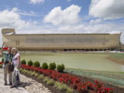 Visitors take a selfie as a replica Noah&#039;s Ark stands in the distance at the Ark Encounter theme park during a media preview day Tuesday in Williamstown, Ky. The long-awaited theme park based opened Thursday.