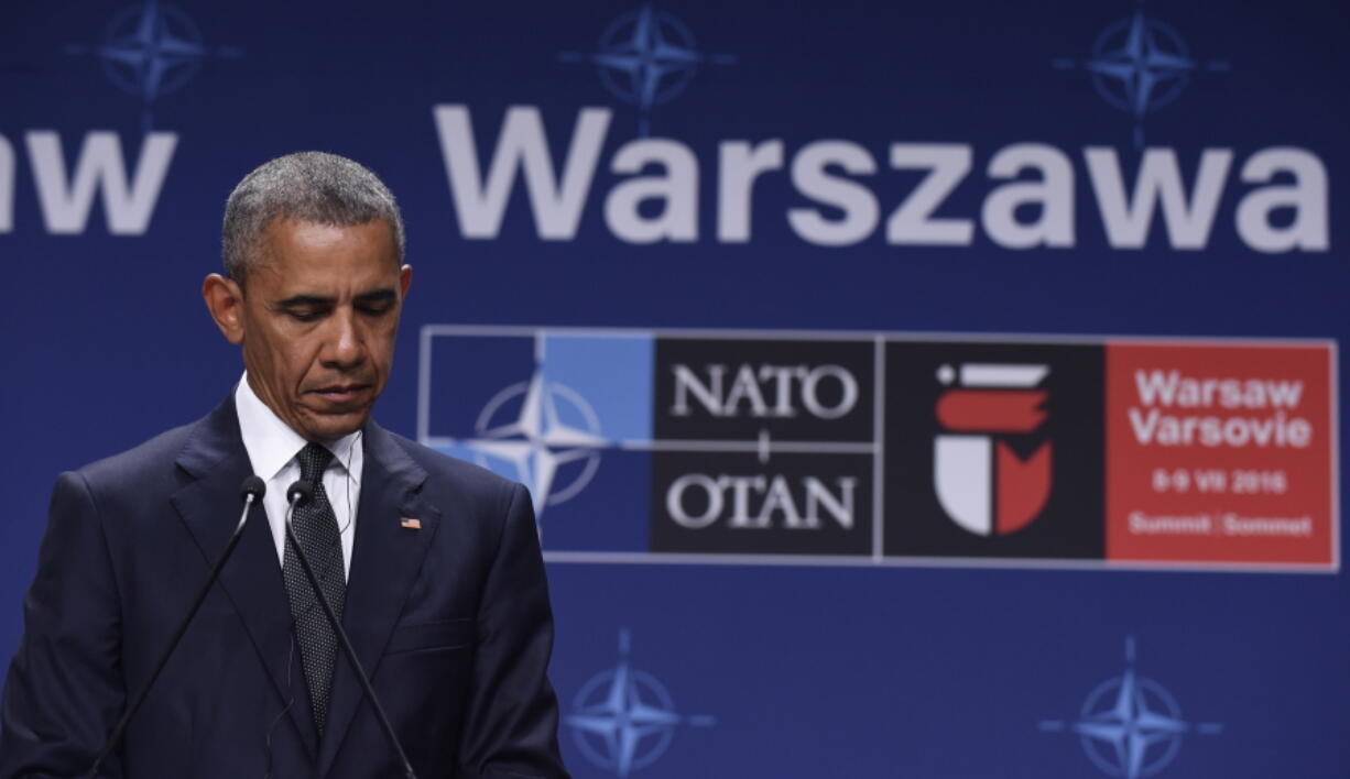 President Barack Obama listens to Polish President Andrzej Duda offering condolences before making statements following their meeting at PGE National Stadium in Warsaw, Poland, on Friday. Obama is in Warsaw to attend the NATO Summit.