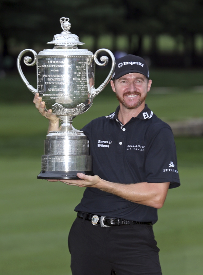 Jimmy Walker poses with the trophy after winning the PGA Championship golf tournament at Baltusrol Golf Club in Springfield, N.J., Sunday, July 31, 2016.