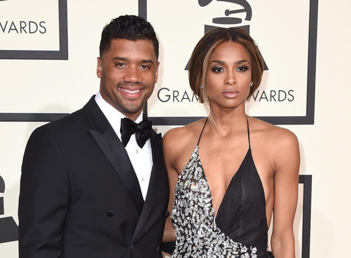 Seattle Seahawks quarterback Russell Wilson, left, and singer Ciara arrive Feb. 15 at the 58th annual Grammy Awards in Los Angeles. The couple were married Wednesday at Peckforton Castle in Cheshire, England.