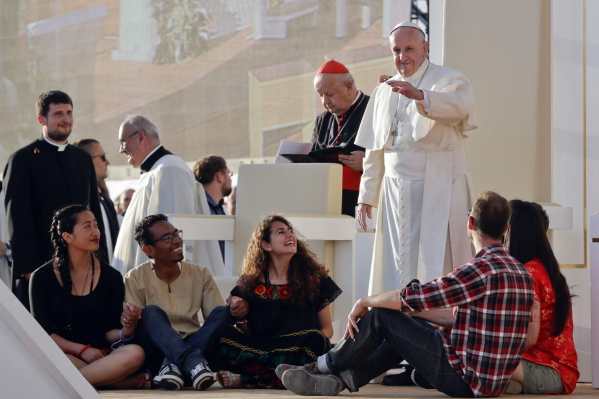 Pope Francis blesses youths ahead of a prayer vigil on the occasion of the World Youth Days, in Campus Misericordiae in Brzegi, near Krakow, Poland, Saturday. The 79-year-old Francis has had an unrelenting schedule since he arrived in Poland on Wednesday for World Youth Days, a global Catholic gathering which culminates Sunday.