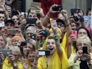 Faithful cheer and take pictures and videos with their phones of Pope Francis arriving by tram in Krakow&#039;s Jordan Park, Poland, on Thursday. The Pope is on a five-day visit to Poland which will culminate with the World Youth Day on Sunday.