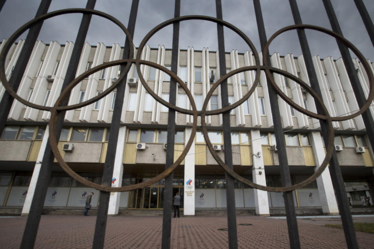 People walk in front of the Russian Olympic Committee building in Moscow.