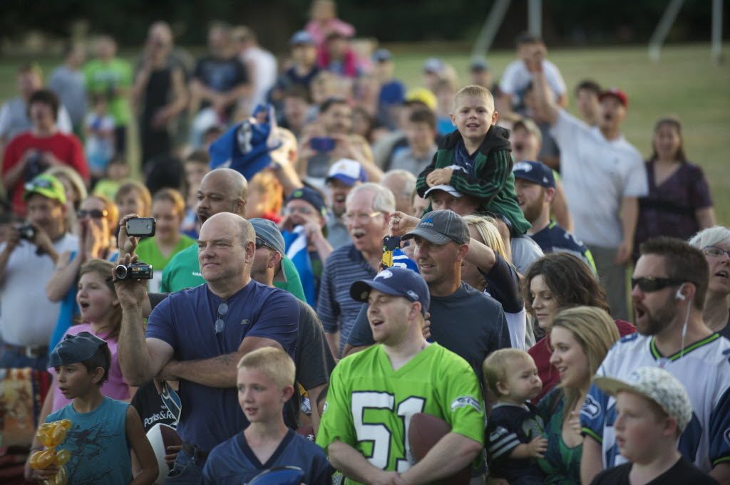 Seattle Seahawks fans chant "Sea-Hawks" at Marshall Community Center Park during a visit by the Seattle Seahawks 12 Tour in 2013.