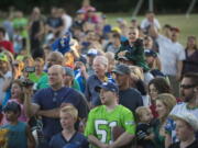 Seattle Seahawks fans chant "Sea-Hawks" at Marshall Community Center Park during a visit by the Seattle Seahawks 12 Tour in 2013.