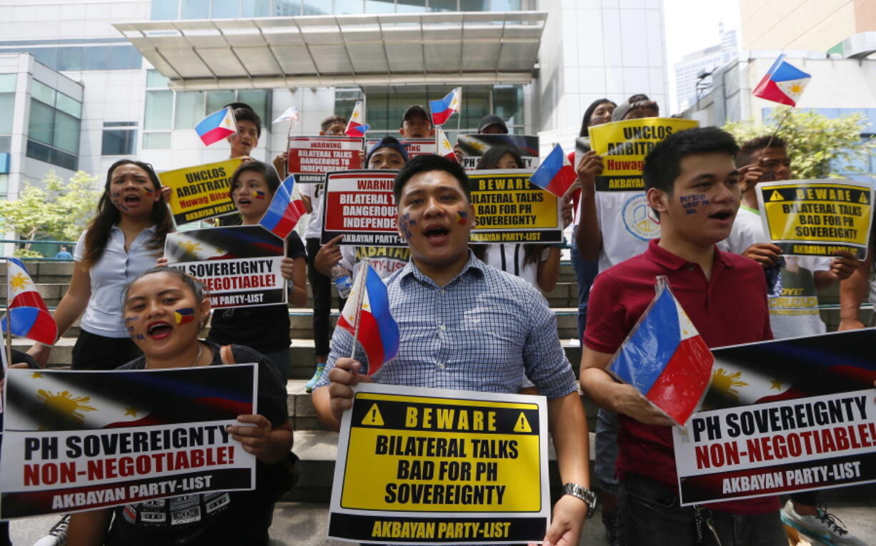 Protesters shout slogans while displaying placards outside the Chinese Consulate in protest of China&#039;s occupation and island-building in the disputed Spratlys islands in the South China Sea.