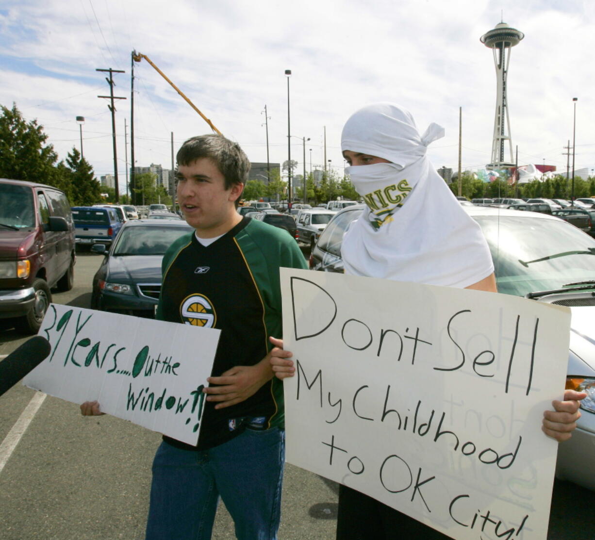 With Seattle's famous Space Needle in the background, Seattle SuperSonics fans Aaron Morse, and Ben Conway, both 18, protest the sale of the NBA basketball team in Seattle on July 18, 2006. July 18, 2016 will mark 10 years since the Seattle SuperSonics — the city's first professional sports franchise — was sold by Starbucks CEO Howard Schultz and the Basketball Club of Seattle to Clayton Bennett and the Professional Basketball Club LLC based in Oklahoma City. (Ted S.