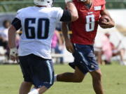 Tennessee Titans quarterback Marcus Mariota (8) celebrates with center Ben Jones (60) after running a play during NFL football training camp Sunday, July 31, 2016, in Nashville, Tenn.