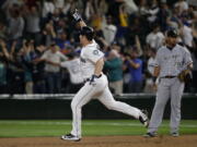 Seattle Mariners&#039; Adam Lind, left, rounds the bases past Chicago White Sox first baseman Jose Abreu, right, after Lind hit a three-run walk-off home run in the ninth inning of a baseball game, Monday, July 18, 2016, in Seattle. The Mariners beat the White Sox 4-3. (AP Photo/Ted S.