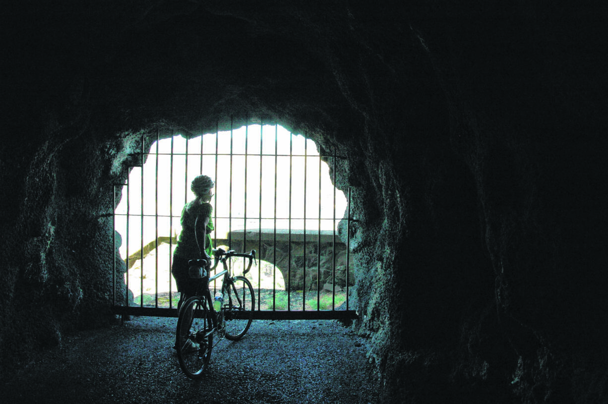 The openings in the Mosier Twin Tunnels, called adits, provide a refreshing breeze for cyclists and hikers using the Historic Columbia River Highway State Trail between Hood River and Mosier in Oregon.