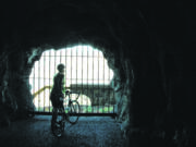 The openings in the Mosier Twin Tunnels, called adits, provide a refreshing breeze for cyclists and hikers using the Historic Columbia River Highway State Trail between Hood River and Mosier in Oregon.