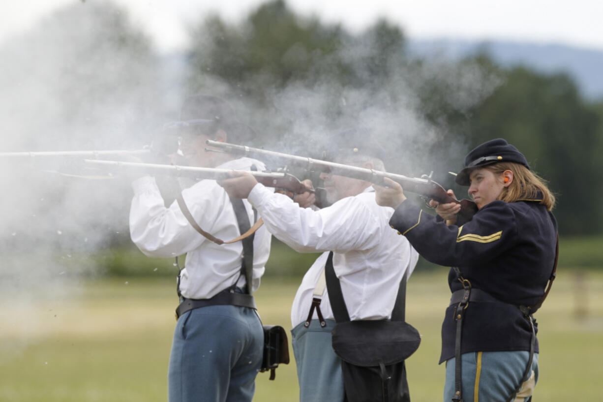 Jacob Duquette, from left, John Miller and Emily Wattez go through the 2014 training program for volunteers who fire black-powder weapons in re-enactments at Fort Vancouver National Historic Site.