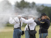 Jacob Duquette, from left, John Miller and Emily Wattez go through the 2014 training program for volunteers who fire black-powder weapons in re-enactments at Fort Vancouver National Historic Site.