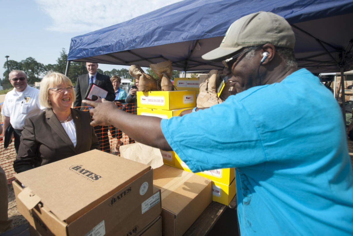 Sen. Patty Murray, R-Wash., meets with veteran Tyrone Brown, who was handing out shoes at the annual veterans stand-down in Vancouver in 2015. The event is a kind of a &quot;1-stop shopping&quot; for veterans who need immediate assistance or long-term resources.