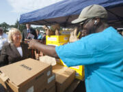 Sen. Patty Murray, R-Wash., meets with veteran Tyrone Brown, who was handing out shoes at the annual veterans stand-down in Vancouver in 2015. The event is a kind of a &quot;1-stop shopping&quot; for veterans who need immediate assistance or long-term resources.