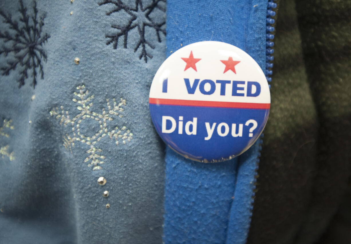 A voter wears an &quot;I Voted&quot; pin at Gaiser Hall, Clark College, in Vancouver on Nov. 3.