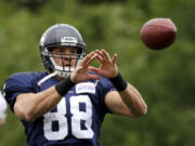 Seattle Seahawks&#039; Jimmy Graham reaches to catch a ball at an NFL football training camp Monday, Aug. 3, 2015, in Renton, Wash.