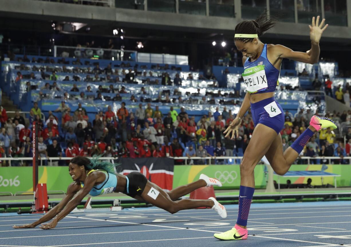 Bahamas' Shaunae Miller falls over the finish line to win gold ahead of United States' Allyson Felix, right, in the women's 400-meter final during the athletics competitions of the 2016 Summer Olympics at the Olympic stadium in Rio de Janeiro, Brazil, Monday, Aug. 15, 2016.