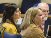 Jessica Smith sits next to defense attorneys William Falls, back, and Lynne Morgan, foreground, at the Clatsop County Courthouse for a status hearing Tuesday, May 12, 2015, in Astoria, Ore.  Smith is charged with aggravated murder and attempted aggravated murder in the drowning death of her 2-year-old and cutting the throat of her teenage daughter in Cannon Beach, Ore.