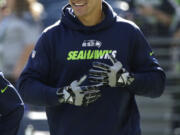 Seattle Seahawks tight end Jimmy Graham smiles as he stands on the field during warmups before an NFL football game against the Chicago Bears, Sunday, Sept. 27, 2015, in Seattle.