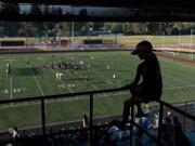 Battle Ground resident Andi Copper, 11, gets a birds-eye view of the field from her perch in the stands while taking in football action with fellow fans Thursday evening at Battle Ground High School.