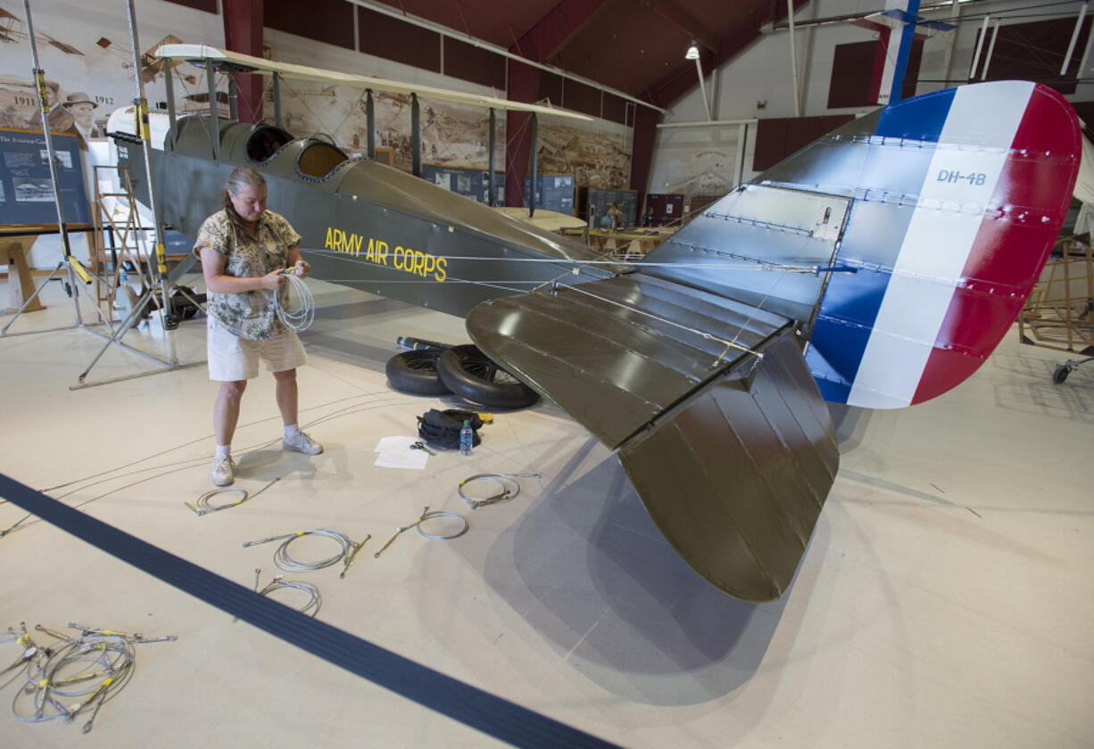 Karen Barrow of Century Aviation assembles Pearson Air Museum&#039;s biplane -- right side up -- Wednesday.