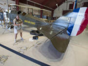 Karen Barrow of Century Aviation assembles Pearson Air Museum&#039;s biplane -- right side up -- Wednesday.