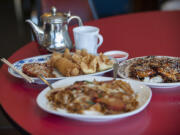 The special plate appetizer, clockwise from back left, is served Aug. 19 with the teriyaki chicken rice bowl and chow fun with roast pork at Tang&#039;s Wok in Vancouver. The items in the appetizer are barbecue pork, shrimp, an egg roll and crab puffs.