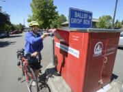 Kelly Cannard drops off her ballot at the ballot drop box Monday on West 14th Street in downtown Vancouver on Monday. Election Day is Tuesday, and voters have until 8 p.m. to submit their ballots in person. Mail-in ballots must be postmarked by Tuesday.