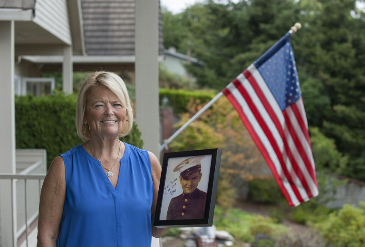 Susie Ehle, daughter of Medal of Honor recipient Robert Bush, at her Lake Shore-area home with the only photo he had taken in a Marine uniform. The Navy medical corpsman was assigned to a Marine rifle company on Okinawa.